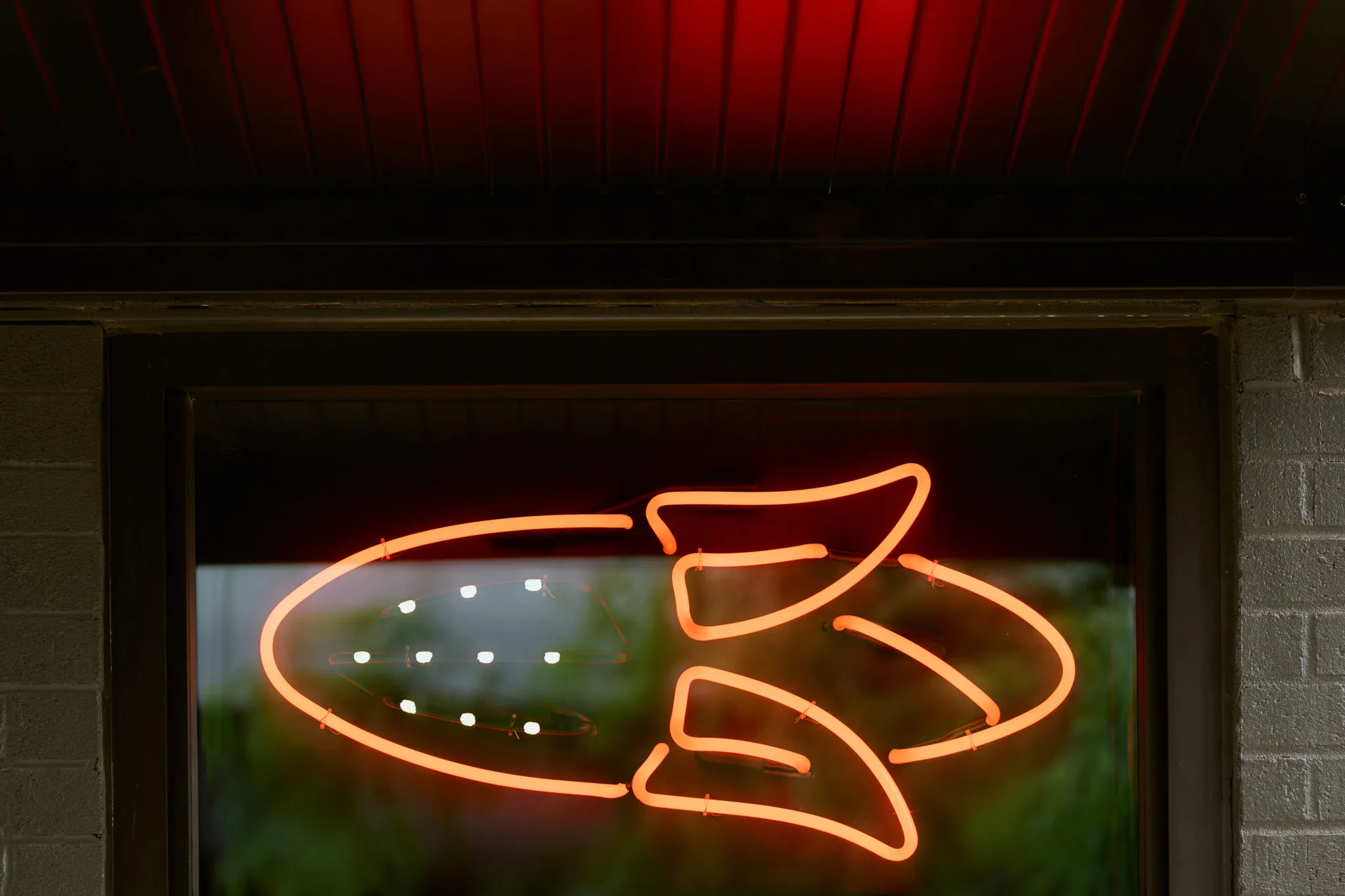 The neon corn sign glowing at night