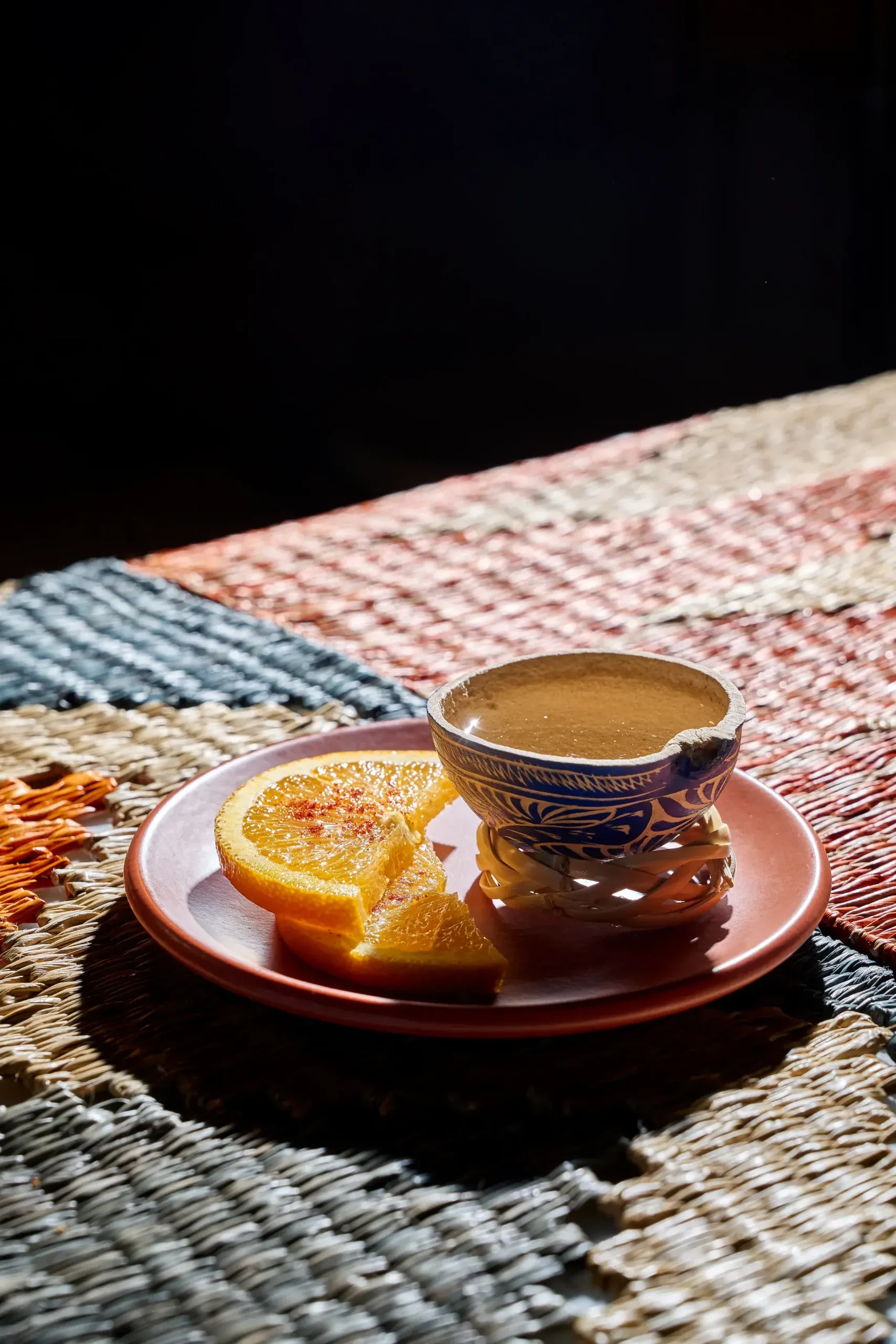 Café de olla served with an orange slice
